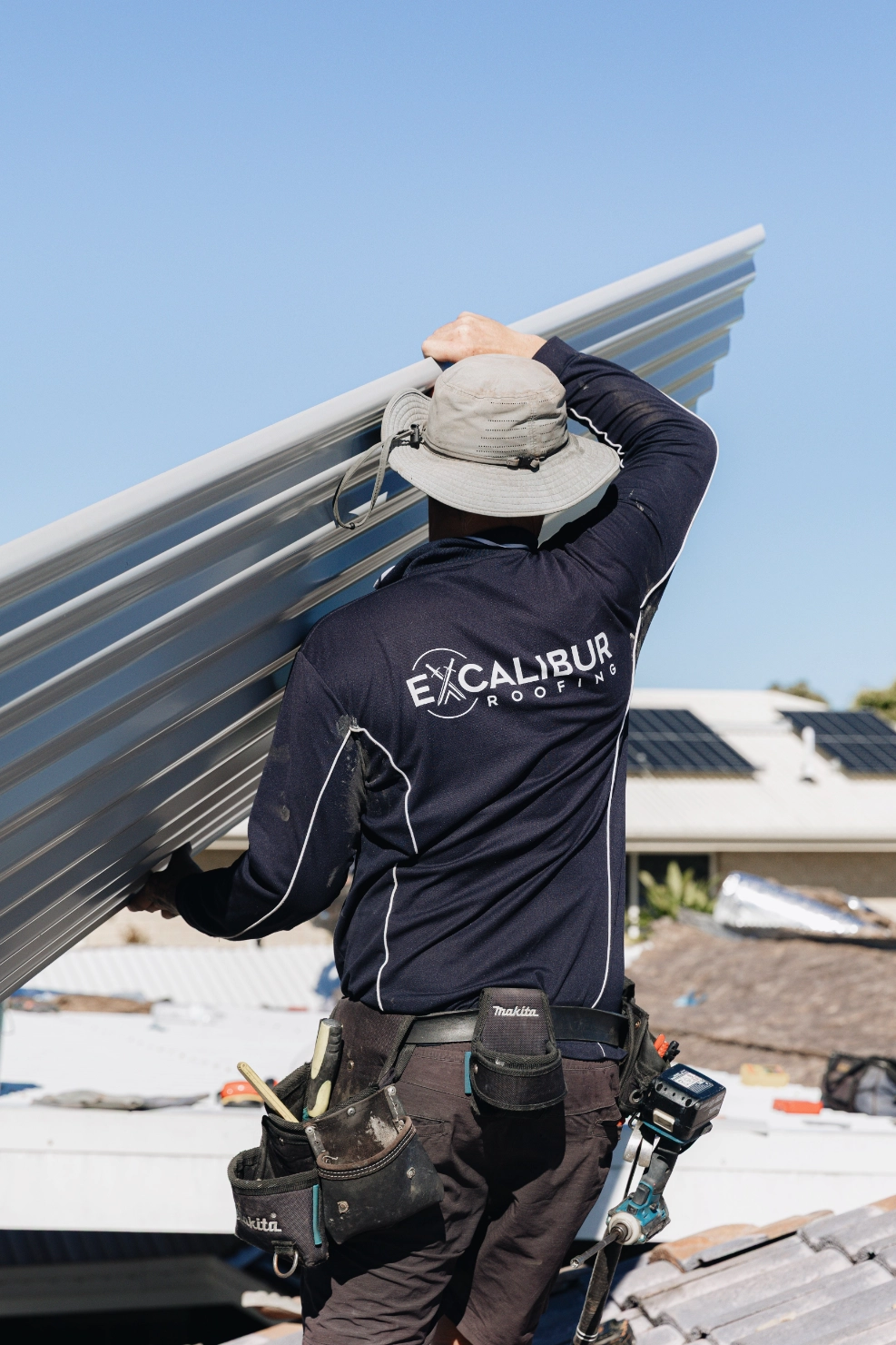 professional roof installer metal sheeting handling